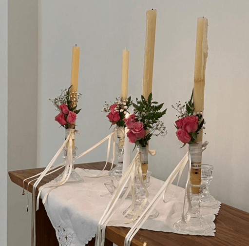 Pentecost candles with roses wrapped around them