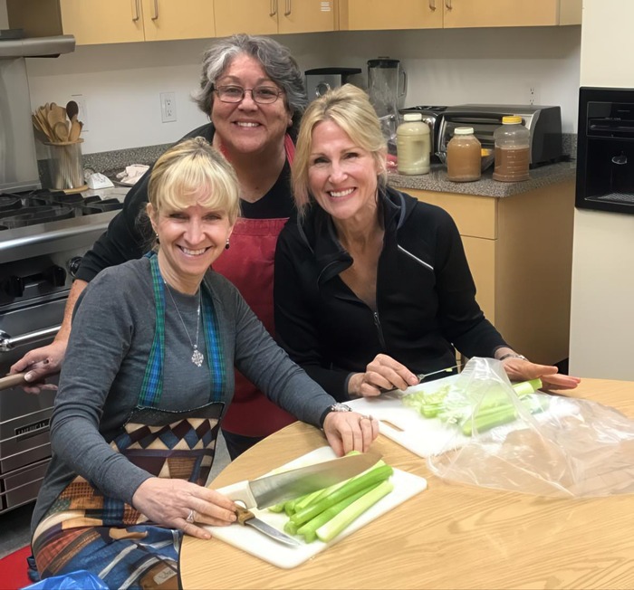 Sr. Albertina and Juniors in a kitchen cutting celery for Thanksgiving dinner 